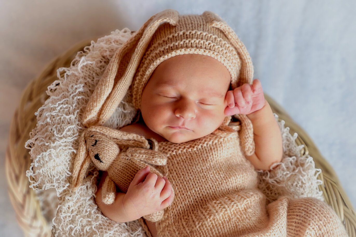 Newborn Baby Holding Teddy Bear